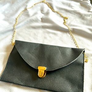 Black clutch with gold chain
